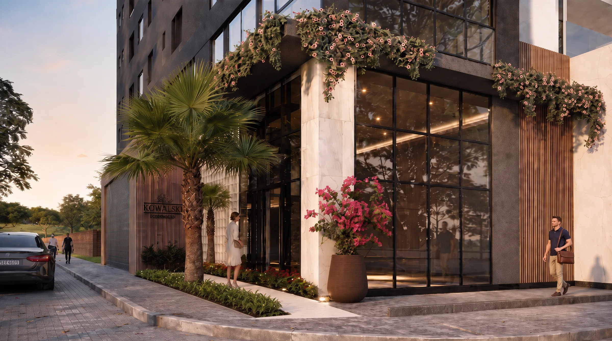 Entrada do Kowalski Residencial, com jardineiras floridas e o letreiro do empreendimento.